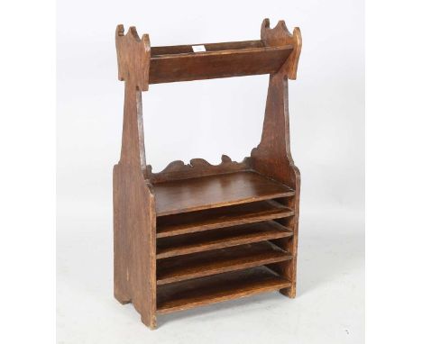 An Edwardian Arts and Crafts oak book trough with open shelf and four horizontal slots, height 82cm, width 48cm, depth 25.5cm