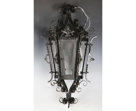 A 20th century wrought iron scrollwork hexagonal tapering hanging lantern, height 61cm.