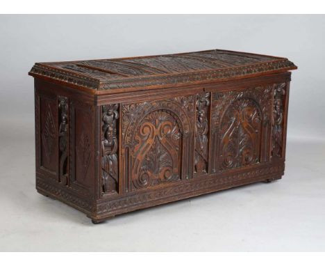 A large early 20th century Continental oak trunk, the hinged lid and sides profusely carved with foliage, height 73cm, width 