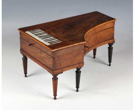 A 19th century mahogany cased novelty musical dressing table étui, modelled as a grand piano, the hinged lid enclosing a lift