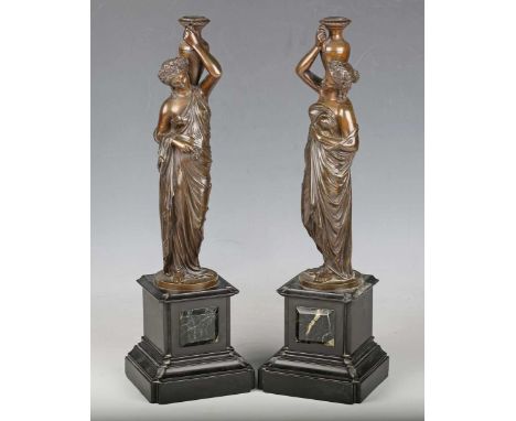 A pair of 19th century French brown patinated cast bronze caryatid figures, each modelled holding an amphora on one shoulder,