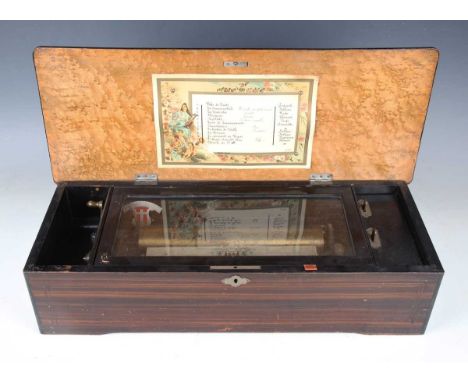 A 19th century Swiss music box, the lever-wind movement playing twelve airs on a 28cm cylinder, the movement and tune sheet n