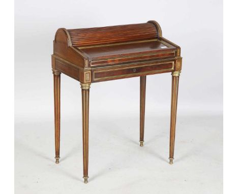 A 19th century French Empire style mahogany and brass mounted writing table, the frieze fitted with a drawer operating a tamb