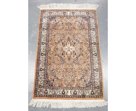 A Moud rug, Central Persia, late 20th century, the pink field with an ivory medallion, within a complimentary border, 124cm x