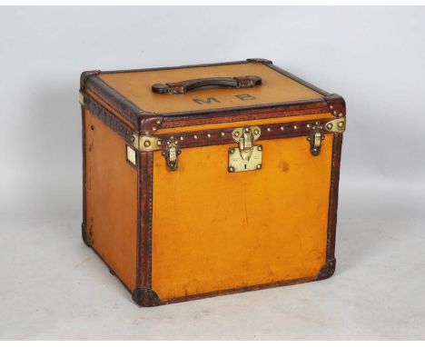 A late 19th/early 20th century Louis Vuitton tan coloured canvas hat trunk with overall leather bound corners and polished br