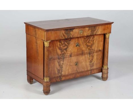 A 19th century French flame mahogany three-drawer commode with applied gilt metal mounts and maple-lined drawers, height 86cm