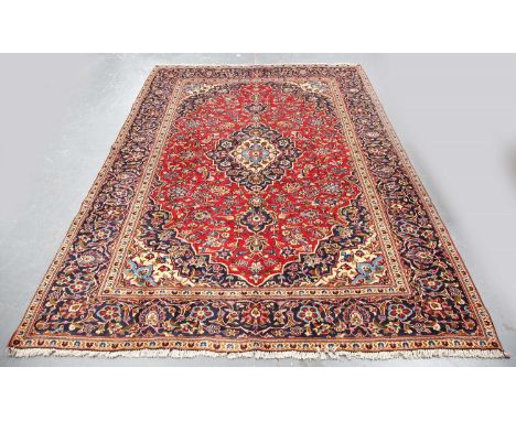 A Kashan carpet, Central Persia, late 20th century, the red field with a shaped medallion, within a flowerhead and palmette b