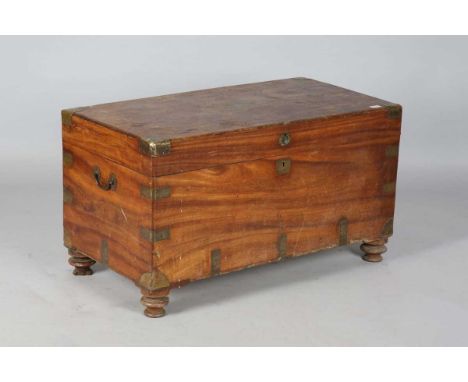 A 19th century Colonial camphor trunk with brass bound corners and handles, on later turned feet, height 57cm, width 102cm, d