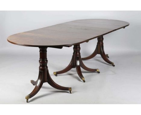A George III and later mahogany triple pillar ‘D’ end dining table, the top with three leaves, raised on three turned columns