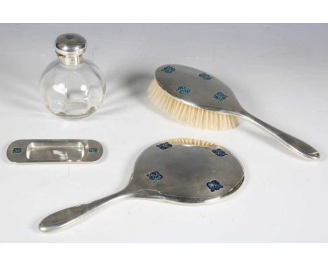 A Liberty &amp; Co 'Cymric' silver and enamelled dressing table set, designed by Archibald Knox, model number '5183', togethe