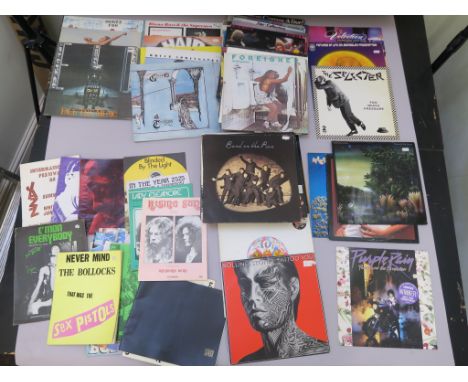 Collection of approx 50+ LPs and concert books. Records include Wings, Fleetwood Mac, Rolling Stones, Queen, ELO, Roger Daltr