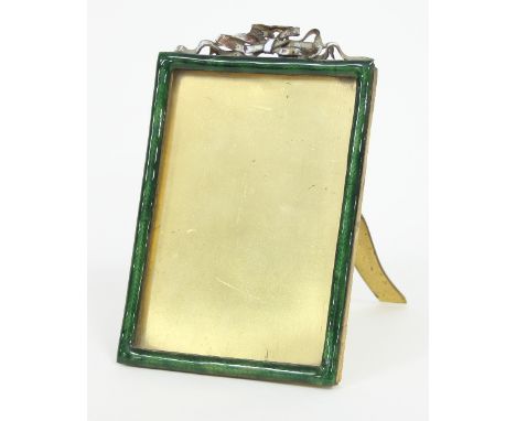 An enamelled easel back photograph frame, surmounted by a ribbon tie, to take a photograph 13.5cm x 9.5cm Condition Report: S