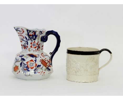 A 19th Century Staffordshire mug, moulded with a hunting scene, an octagonal hydra jug with Imari decoration, a pair of black