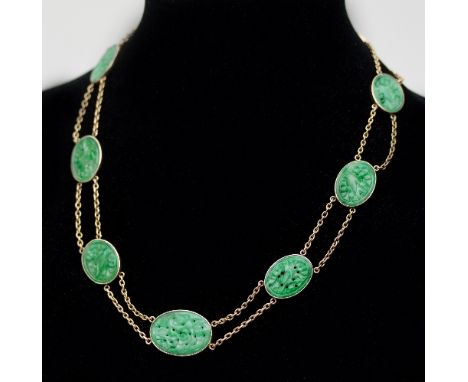 A Chinese jade plaque necklace, the nine oval plaques with pierced carved decoration joined by a double chain necklace to an 