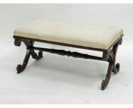An early Victorian upholstered duet stool, on carved X-shaped end supports united by a turned stretcher, 91.5cm wide