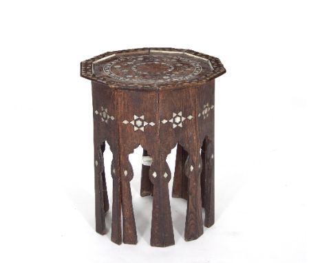 An oak and mother-of-pearl table with decagonal shaped top on shaped legs, stylised mother-of-pearl, bearing Liberty label to