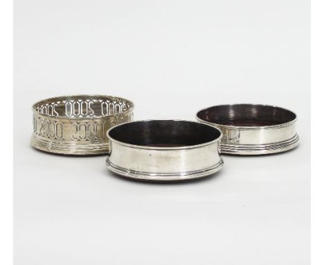 Three modern silver wine coasters, each circular with a turned wood base Condition Report: 446:
Pierced coaster - Wood needs 