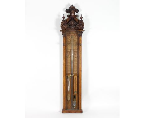 An Admiral Fitzroy barometer, the Victorian Gothic oak case with carved surmount and arch top, with glass barometric and humi