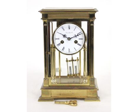 A brass four-glass mantel clock by The London Clock Company, fitted an eight-day movement, half-hour striking on two bells, 2