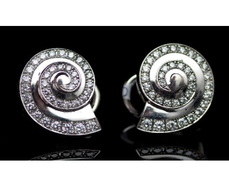 A pair of diamond ear studs by Chopard, each of shell spiral form set in 18ct white gold, signed and numbered