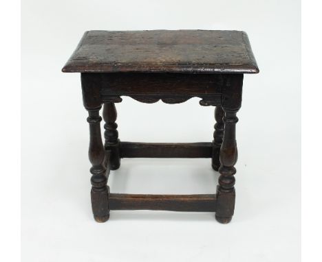 An oak joint stool, the rectangular top with moulded border, on bulbous turned legs and square stretchers, 45cm wide