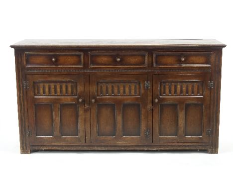 An Ercol oak dresser base, of 17th Century style, 156cm wide, an Ercol bureau and a nest of Ercol oak tables