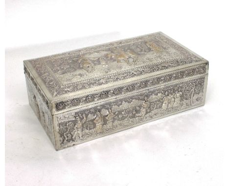 A Chinese export white metal box, of rectangular shape, the hinged cover depicting armed horsemen in a landscape within a bor