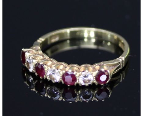 A seven-stone ruby and diamond ring, the alternating stones to an 18ct yellow gold shank, ring size K½
 