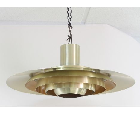 A 1960s Heals pendant light fitting, the brushed metal with gilt finish, of circular form with tiered circular bands to centr