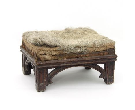 A Victorian gothic oak stool with arched supports, 37cm wide (in need of re-upholstery)
