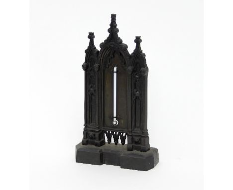 A George IV gothic thermometer stand chimney ornament, with triple arch back surmounted four grotesque masks, 23.5cm high