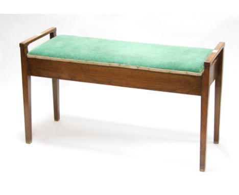 Cotswold School, 20th Century/An oak duet piano stool, with hinged cover on square tapered legs, 97cm wide