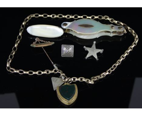 A pair of mother-of-pearl cased lorgnettes, with sprung mechanism, a shield shaped locket with bloodstone to the cover on a y