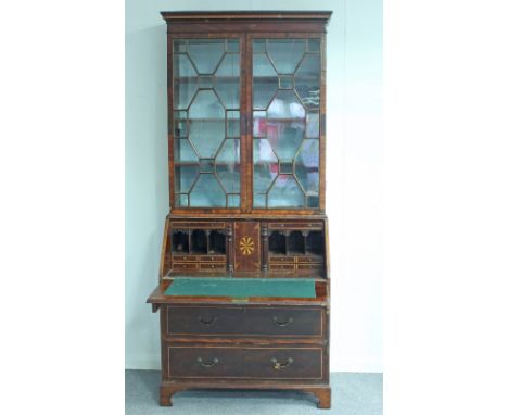A 19th Century mahogany bureau bookcase, the astragal glazed doors above a fall enclosing a fitted desk interior, above three