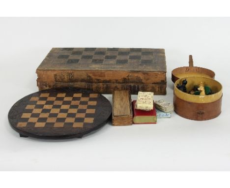 A leather chess and backgammon board, with simulated book spine, an ebony and boxwood chess set and other games Condition Rep