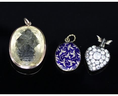 An intaglio carved pendant, depicting a mother holding two children and with another two tugging at her skirts, set in a yell