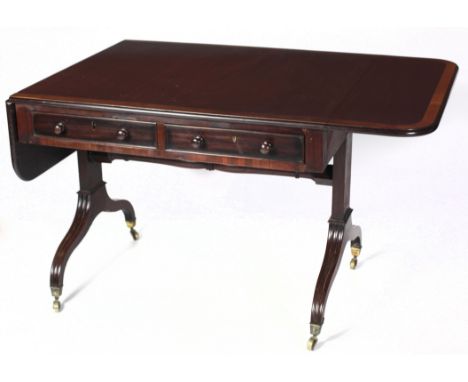 A desirable Georgian period mahogany Sofa Table, the rectangular top with large border of satinwood crossbanding, incorporati