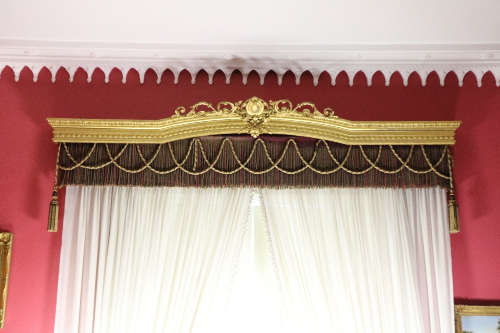 An extremely fine matching suite of three early 19th Century carved giltwood Curtain Pelmets, the