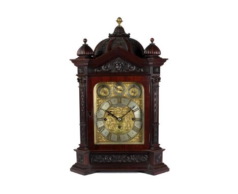 A very good quality Edwardian mahogany Bracket Clock, the domed and carved top with brass finial, flanked by two further shap