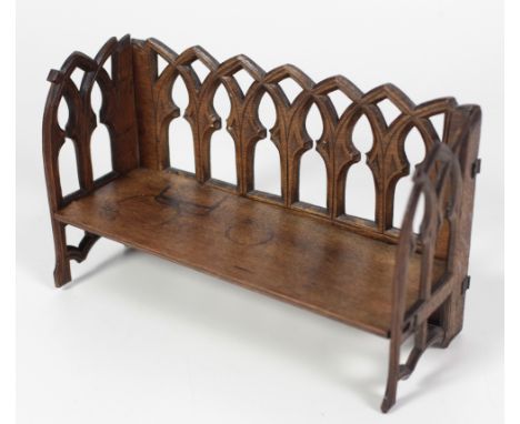 An unusual 19th Century carved and pierced oak Book Trough, designed in the Gothic taste and modelled as a bench, approx. 38c