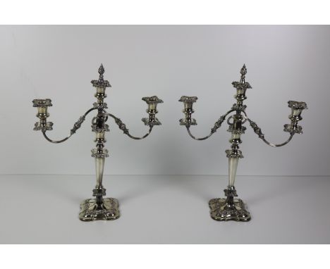 A pair of large silver plated two branch, three light Candelabra, with embossed decoration, 51cms (20") high. (1)