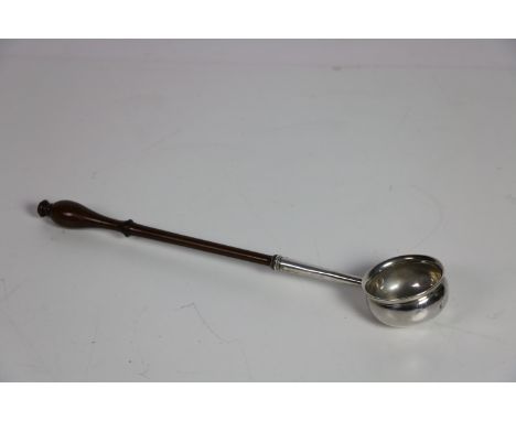 An early 19th Century English silver Punch Ladle, with turned wooden handle, London c. 1806, by J.C.?, approx. 34.5cms (13 1/