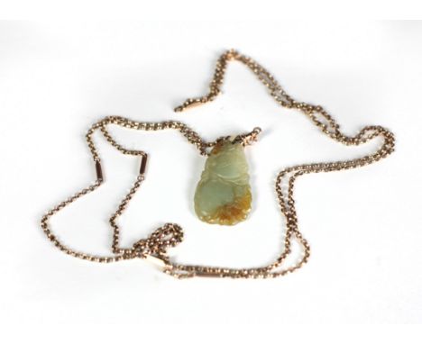 A quality carved green jade Pendant, modelled as pomegranates, with a 9ct gold link chain, approx. 58" long (hall marked). (1