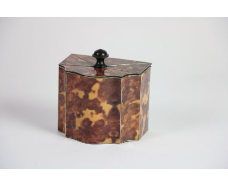 A faux tortoiseshell Tea Caddy, with silver inlay and serpentine shaped with hinged cover, 11cms (4 1/2"). (1)