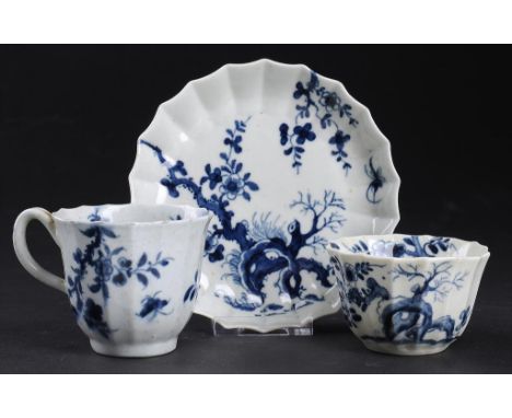 AN EARLY WORCESTER BLUE AND WHITE FLUTED TRIO,  c1756-60 painted with the Prunus Root pattern, saucer 11.5cm diam, workmen's 
