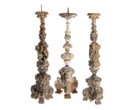 ONE AND A PAIR OF ITALIAN GILTWOOD ALTER CANDLESTICKS, LATE 16TH C  the pair with salomonic upper column supported by a kneel