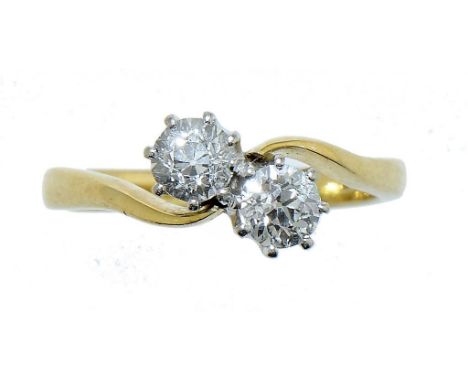 A DIAMOND CROSSOVER RING  in 18ct gold, London 1991, size K++In excellent second hand condition.  The two diamonds weighing a