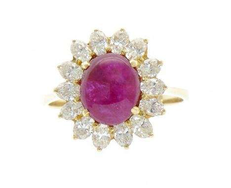 A RUBY AND DIAMOND CLUSTER RING  the central ruby en cabochon, in gold, size O++In fine second hand condition, the ruby estim