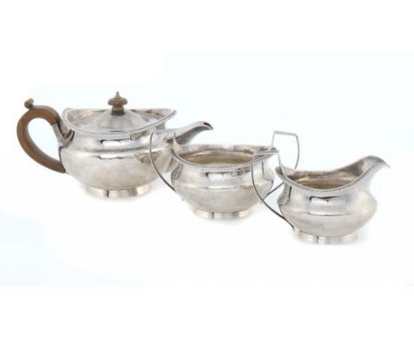 A GEORGE III SILVER TEA SERVICE  the teapot with integral hinge and engraved Greek key border, crested, 11cm h, by Robert, Da