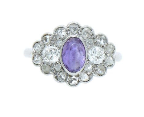 AN AMETHYST AND DIAMOND RING, C1930  size K++In good original condition, the two larger diamonds flanking the oval amethyst c